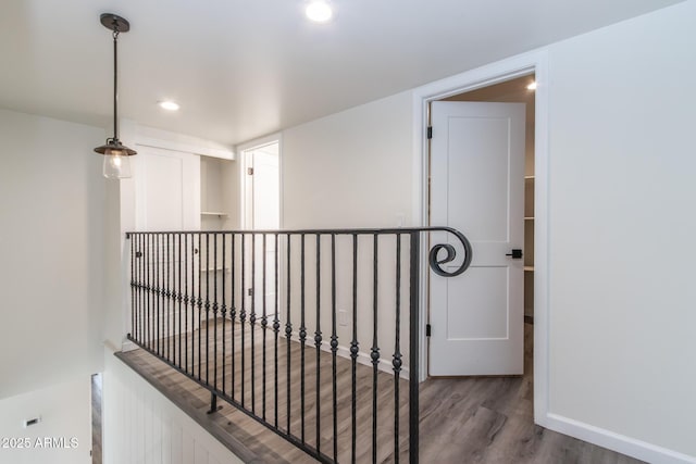 hall featuring an upstairs landing, recessed lighting, baseboards, and wood finished floors