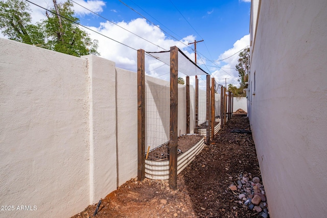 view of side of property featuring stucco siding and fence private yard