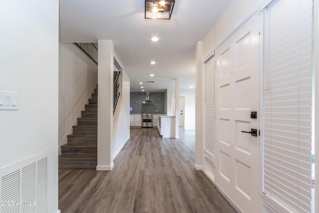 foyer featuring recessed lighting, visible vents, wood finished floors, and stairs