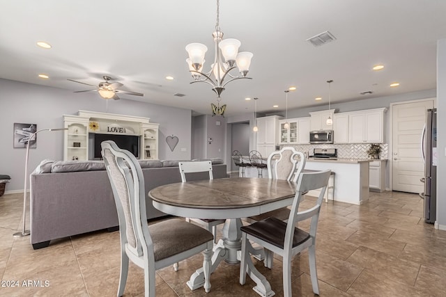 dining space featuring ceiling fan with notable chandelier, visible vents, baseboards, and recessed lighting