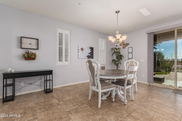 dining area with baseboards and an inviting chandelier