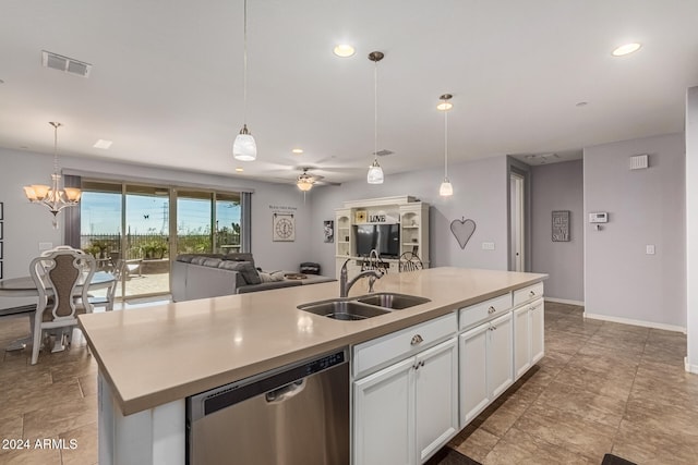 kitchen with decorative light fixtures, visible vents, open floor plan, a sink, and dishwasher