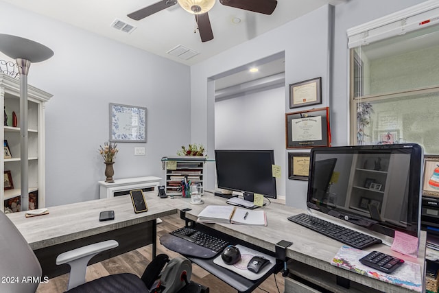 home office featuring ceiling fan, visible vents, and wood finished floors