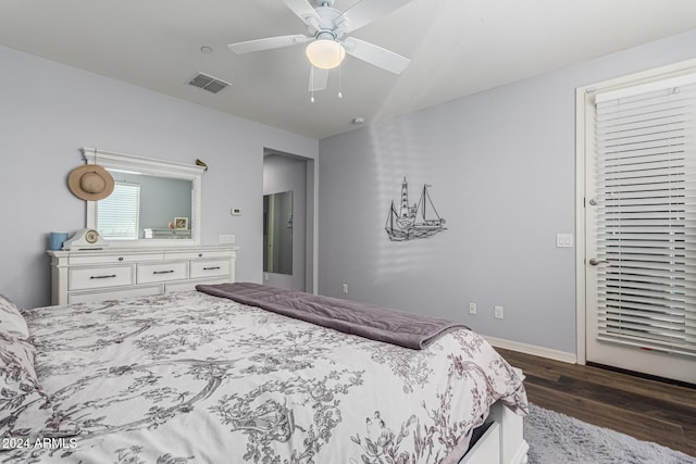 bedroom with baseboards, ceiling fan, visible vents, and dark wood-style flooring