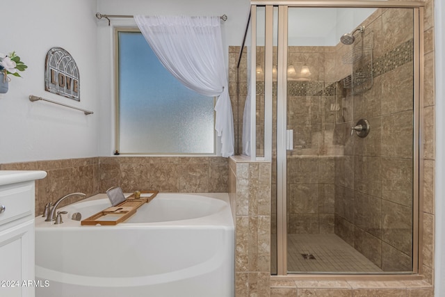 bathroom with a garden tub, a shower stall, and a sink