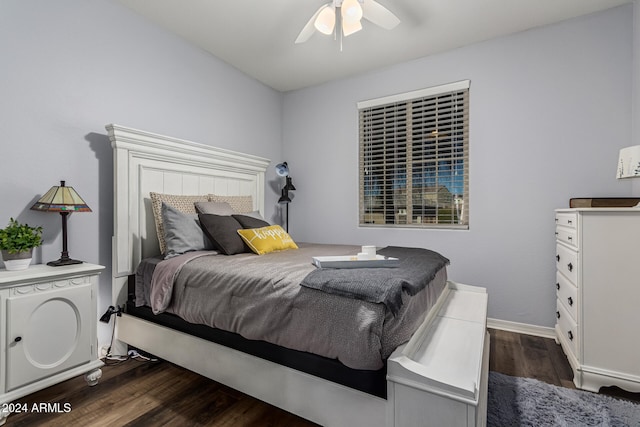 bedroom featuring dark wood-style floors, baseboards, and a ceiling fan