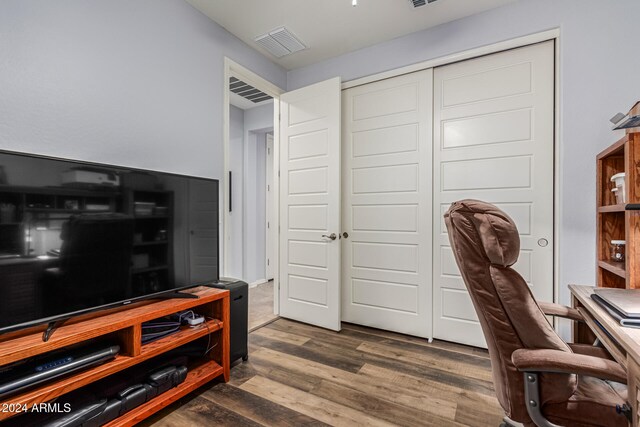 home office featuring visible vents and wood finished floors