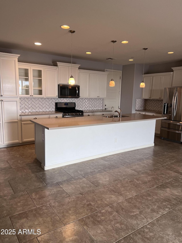 10637 W Eucalyptus Rd, Peoria, AZ 85383 - kitchen with stainless steel appliances, backsplash, a sink, a center island with sink, and decorative light fixtures