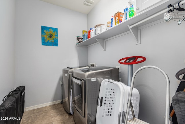 washroom featuring baseboards, laundry area, visible vents, and washer and dryer