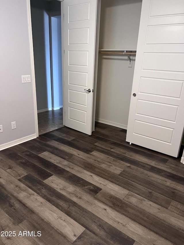10637 W Eucalyptus Rd, Peoria, AZ 85383 - unfurnished bedroom with dark wood-style flooring, baseboards, and a closet