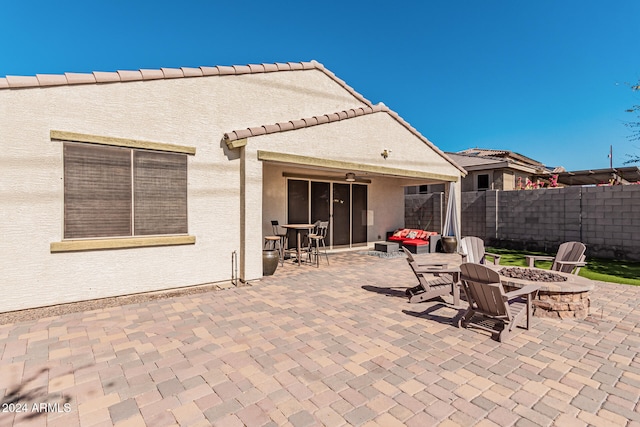 view of patio / terrace with an outdoor fire pit and fence