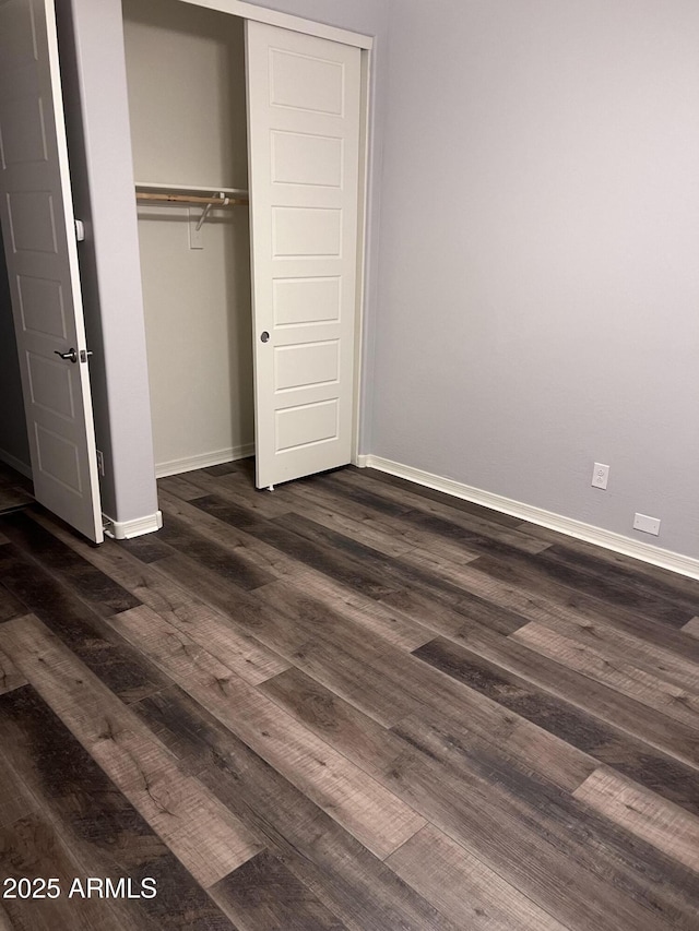 10637 W Eucalyptus Rd, Peoria, AZ 85383 - unfurnished bedroom with baseboards, dark wood-type flooring, and a closet