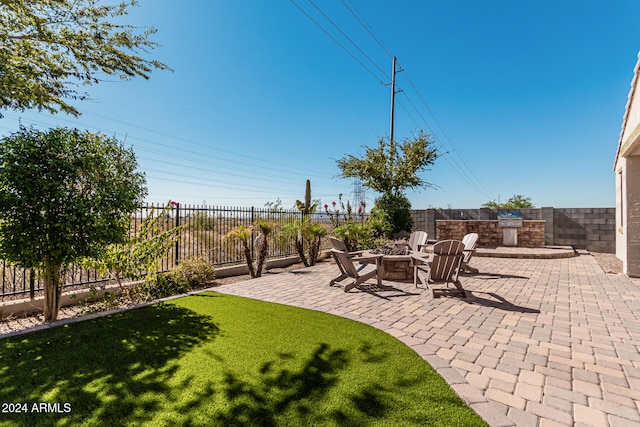 view of yard featuring a patio, an outdoor fire pit, and a fenced backyard