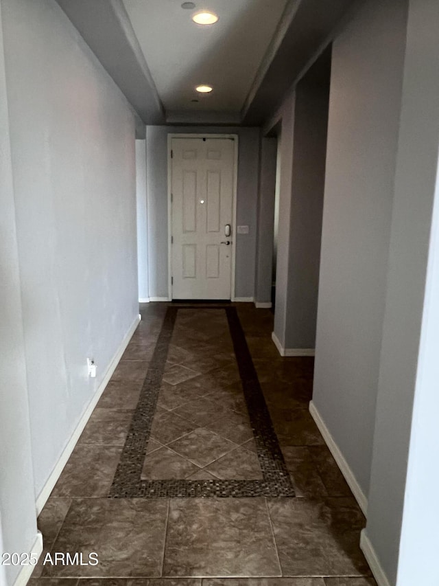 hall featuring recessed lighting and baseboards