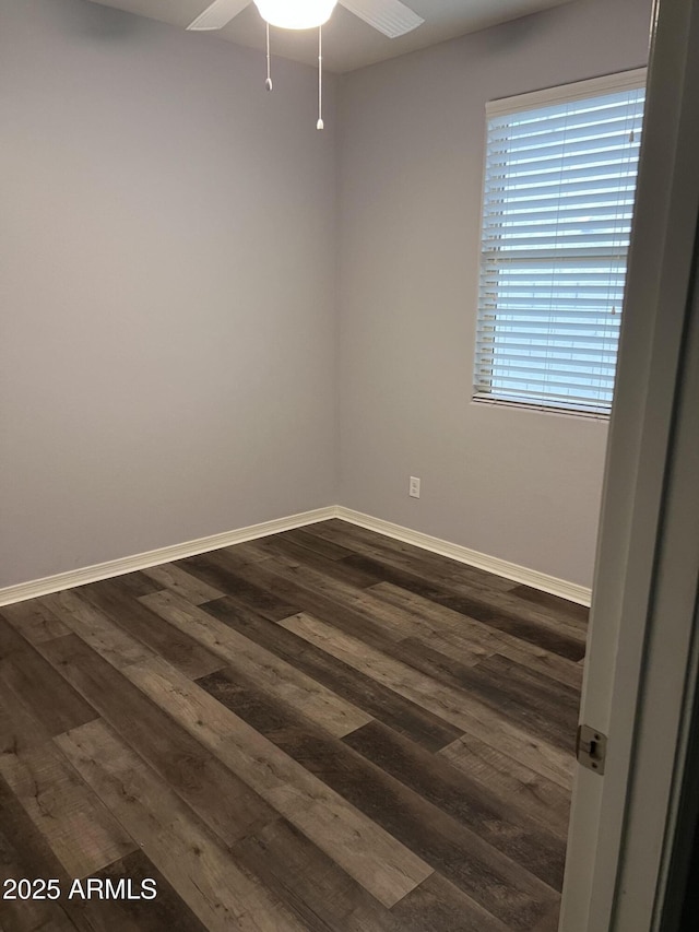 empty room with dark wood-type flooring, ceiling fan, and baseboards