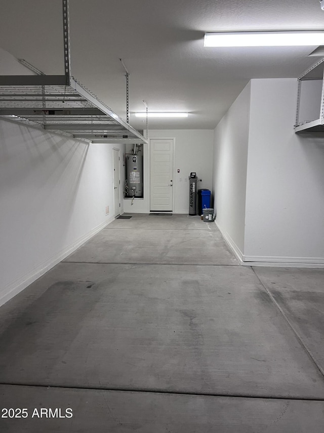 garage with water heater and baseboards