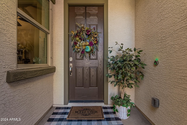 property entrance with stucco siding