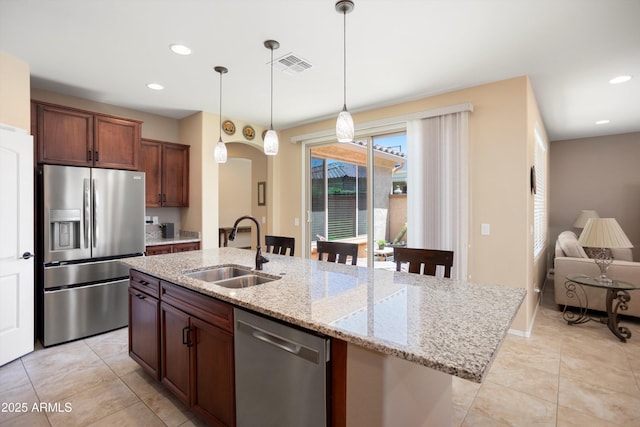 kitchen with stainless steel appliances, visible vents, a sink, and light tile patterned floors