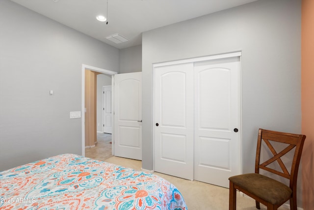 bedroom with light colored carpet and a closet