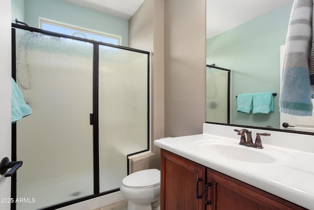 full bath with toilet, a shower stall, and vanity