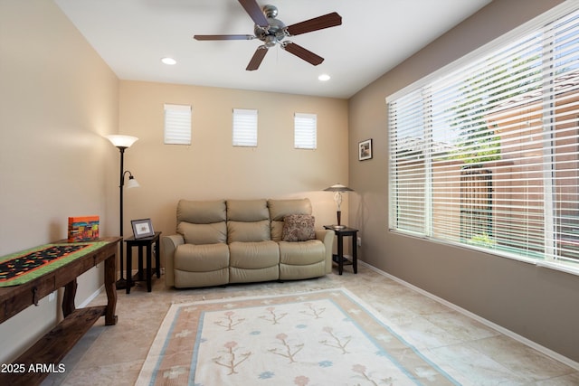 living area featuring baseboards, a ceiling fan, and recessed lighting