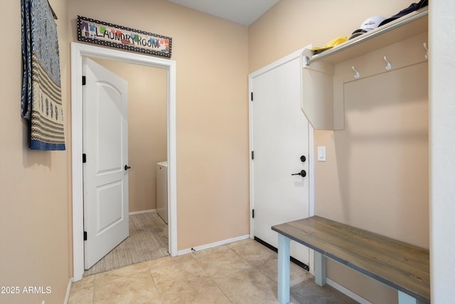 mudroom featuring baseboards and light tile patterned flooring