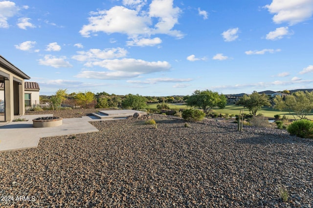 view of yard featuring a patio and an outdoor fire pit