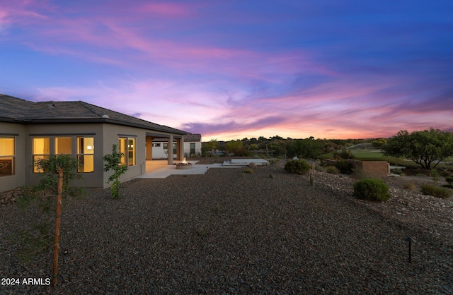 yard at dusk with a patio area