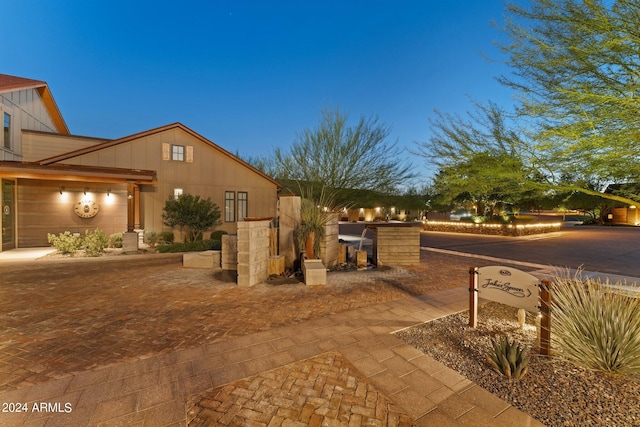 patio terrace at dusk featuring exterior kitchen