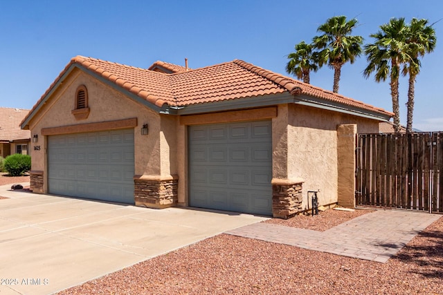 1625 E Daisy St, Casa Grande, AZ 85122 - view of front facade featuring stucco siding, fence, an attached garage, and driveway