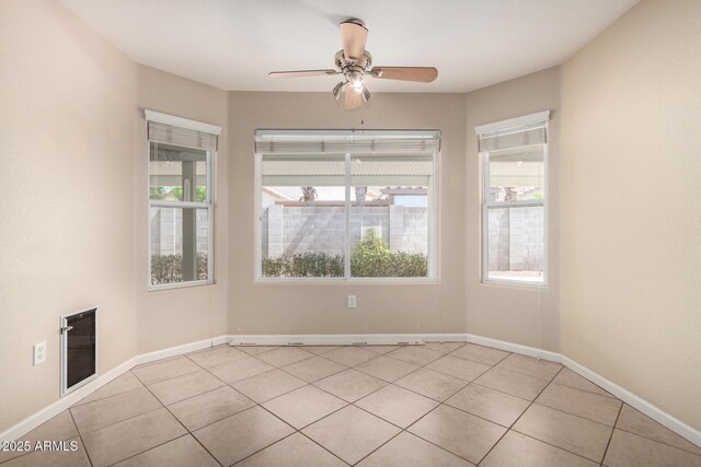 1625 E Daisy St, Casa Grande, AZ 85122 - empty room with light tile patterned flooring, plenty of natural light, a ceiling fan, and baseboards