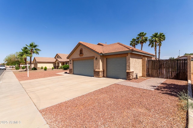 1625 E Daisy St, Casa Grande, AZ 85122 - ranch-style home featuring stucco siding, concrete driveway, a garage, a tile roof, and fence