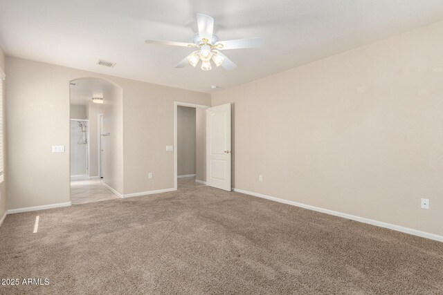 1625 E Daisy St, Casa Grande, AZ 85122 - unfurnished bedroom featuring arched walkways, light colored carpet, baseboards, and a ceiling fan