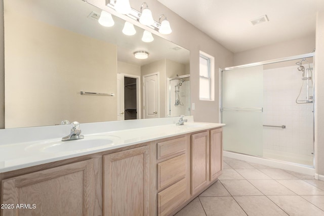 1625 E Daisy St, Casa Grande, AZ 85122 - bathroom with a shower stall, tile patterned flooring, double vanity, and a walk in closet