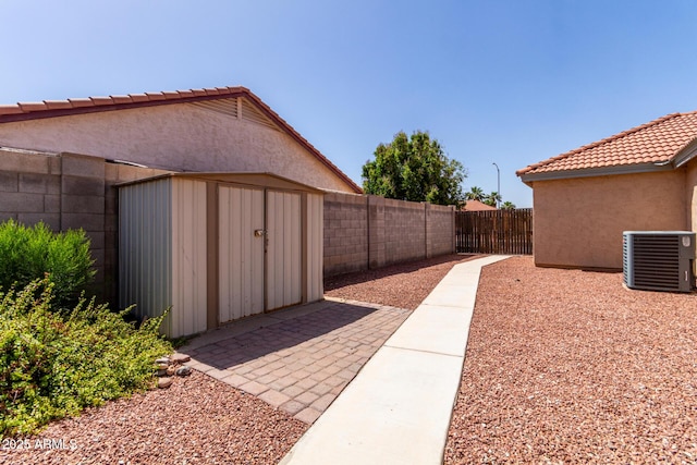 1625 E Daisy St, Casa Grande, AZ 85122 - fenced backyard with cooling unit, a storage unit, and an outbuilding