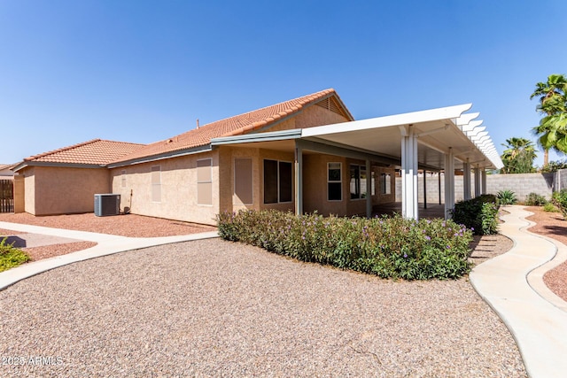 1625 E Daisy St, Casa Grande, AZ 85122 - view of side of property featuring central air condition unit, fence, stucco siding, and a tile roof