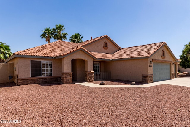 1625 E Daisy St, Casa Grande, AZ 85122 - mediterranean / spanish-style home with stone siding, stucco siding, concrete driveway, and a garage