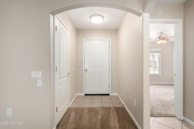 1625 E Daisy St, Casa Grande, AZ 85122 - hallway featuring arched walkways, light tile patterned floors, light carpet, and baseboards