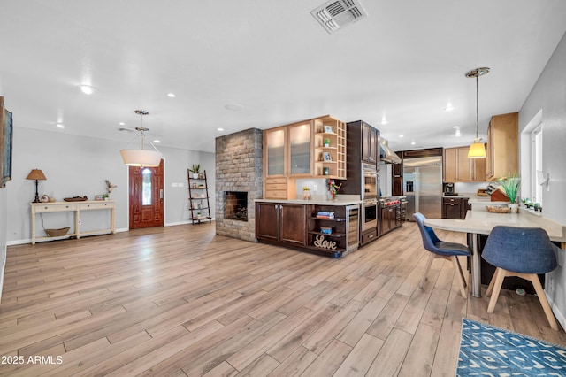 5621 N 13th St, Phoenix, AZ 85014 - living room with light wood-style floors, baseboards, recessed lighting, and a multi sided fireplace