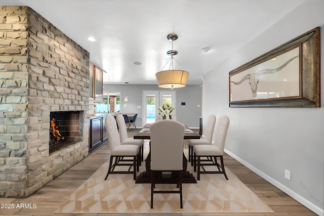 5621 N 13th St, Phoenix, AZ 85014 - dining space featuring wood finished floors, a fireplace, and baseboards