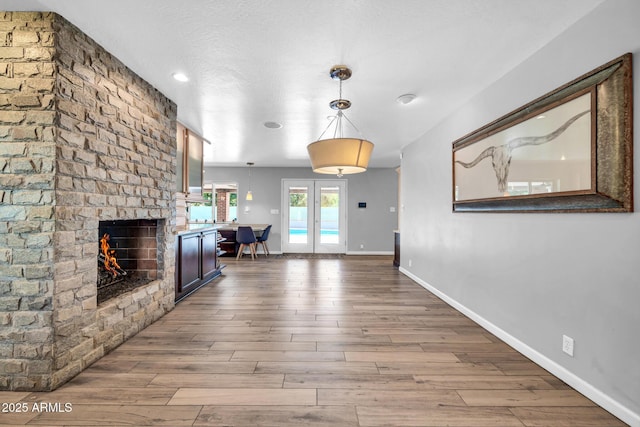 5621 N 13th St, Phoenix, AZ 85014 - living room featuring wood finished floors, baseboards, and a brick fireplace