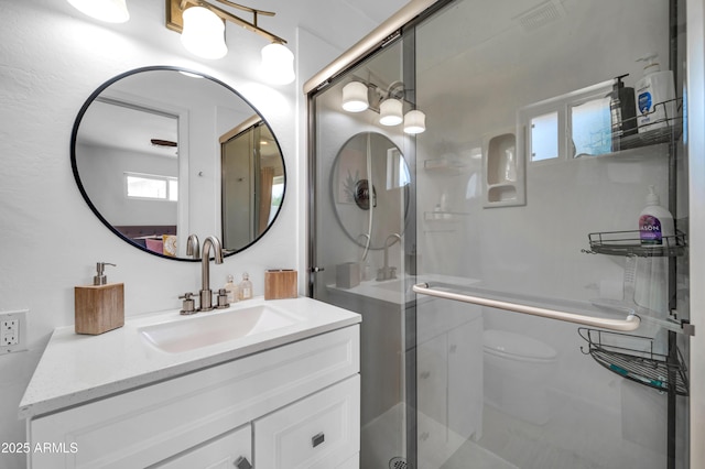 5621 N 13th St, Phoenix, AZ 85014 - bathroom featuring vanity, a shower with door, and toilet