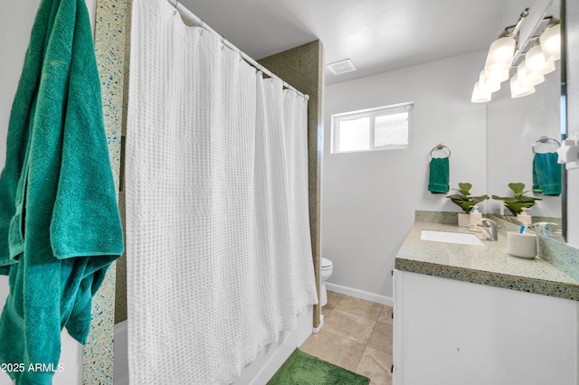 5621 N 13th St, Phoenix, AZ 85014 - full bathroom featuring vanity, toilet, shower / tub combo with curtain, tile patterned floors, and baseboards