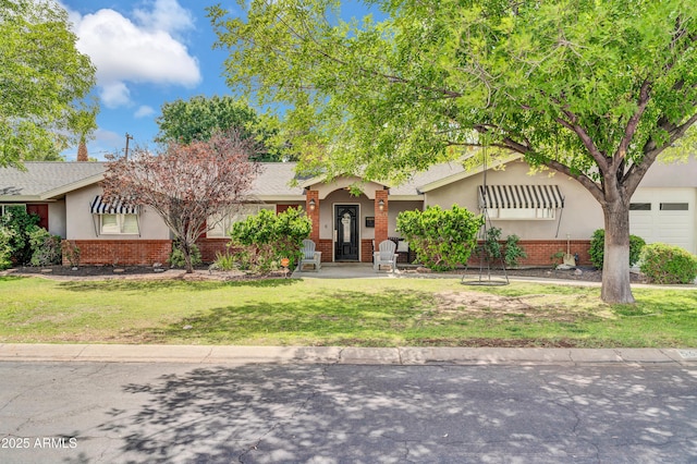 5621 N 13th St, Phoenix, AZ 85014 - obstructed view of property with brick siding, a front lawn, stucco siding, and roof with shingles