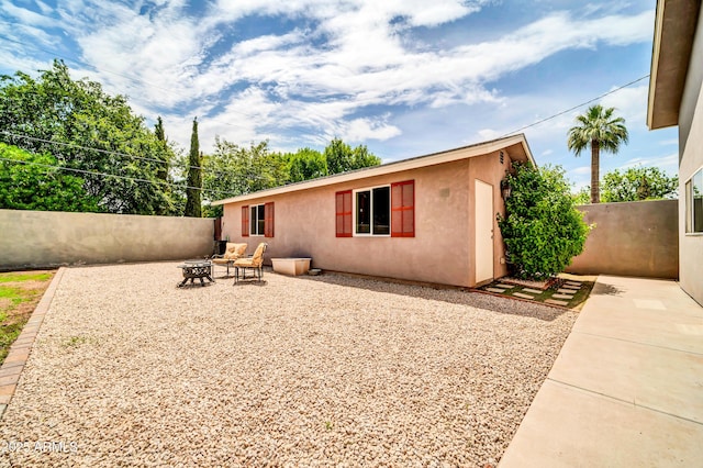 5621 N 13th St, Phoenix, AZ 85014 - rear view of property featuring an outdoor fire pit, stucco siding, and a patio
