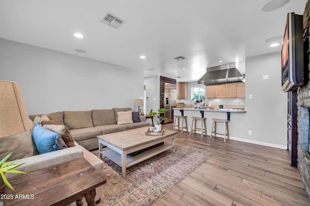 5621 N 13th St, Phoenix, AZ 85014 - living room featuring light wood-style floors, recessed lighting, and baseboards
