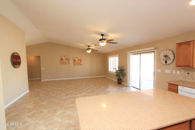 kitchen with vaulted ceiling, light tile flooring, backsplash, dishwasher, and ceiling fan