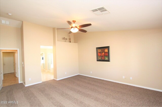 interior space with high vaulted ceiling, ceiling fan, carpet floors, and connected bathroom