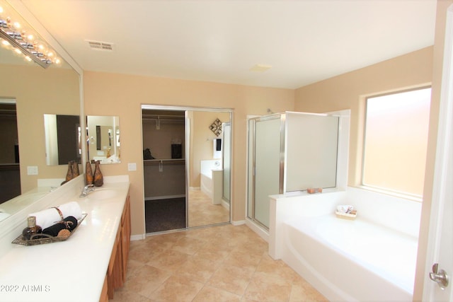 bathroom with independent shower and bath, dual vanity, and tile floors