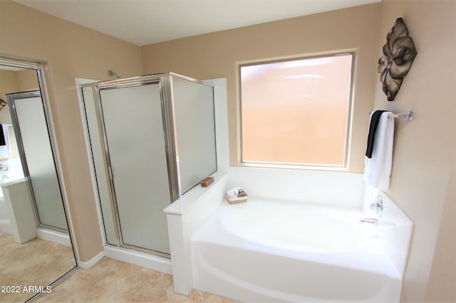 bathroom with tile flooring and independent shower and bath